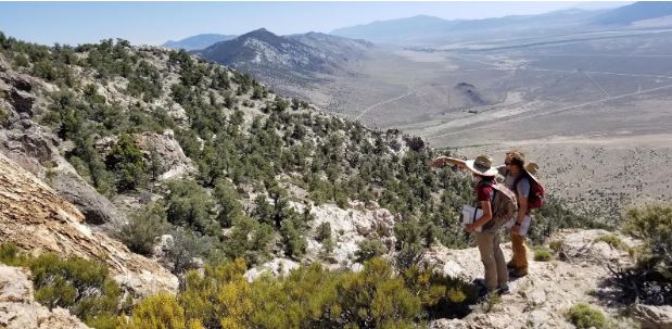 Two students looking out into the chapparal