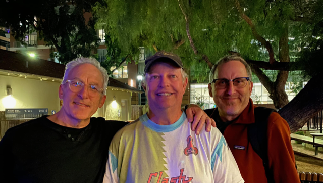 Peter, Bob, and Kevin, no longer young students, posing at the International House
