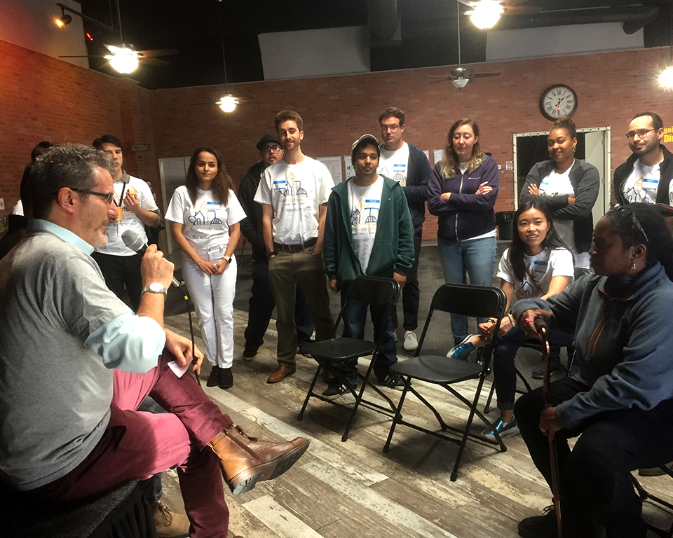 Students gathered in a room, attention on lecturer